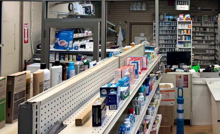 Inside Unicare Pharmacy: stocked aisles leading to the pharmacy counter
